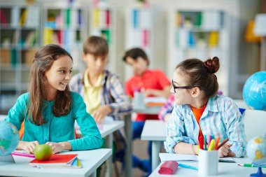 Girls talking in classroom